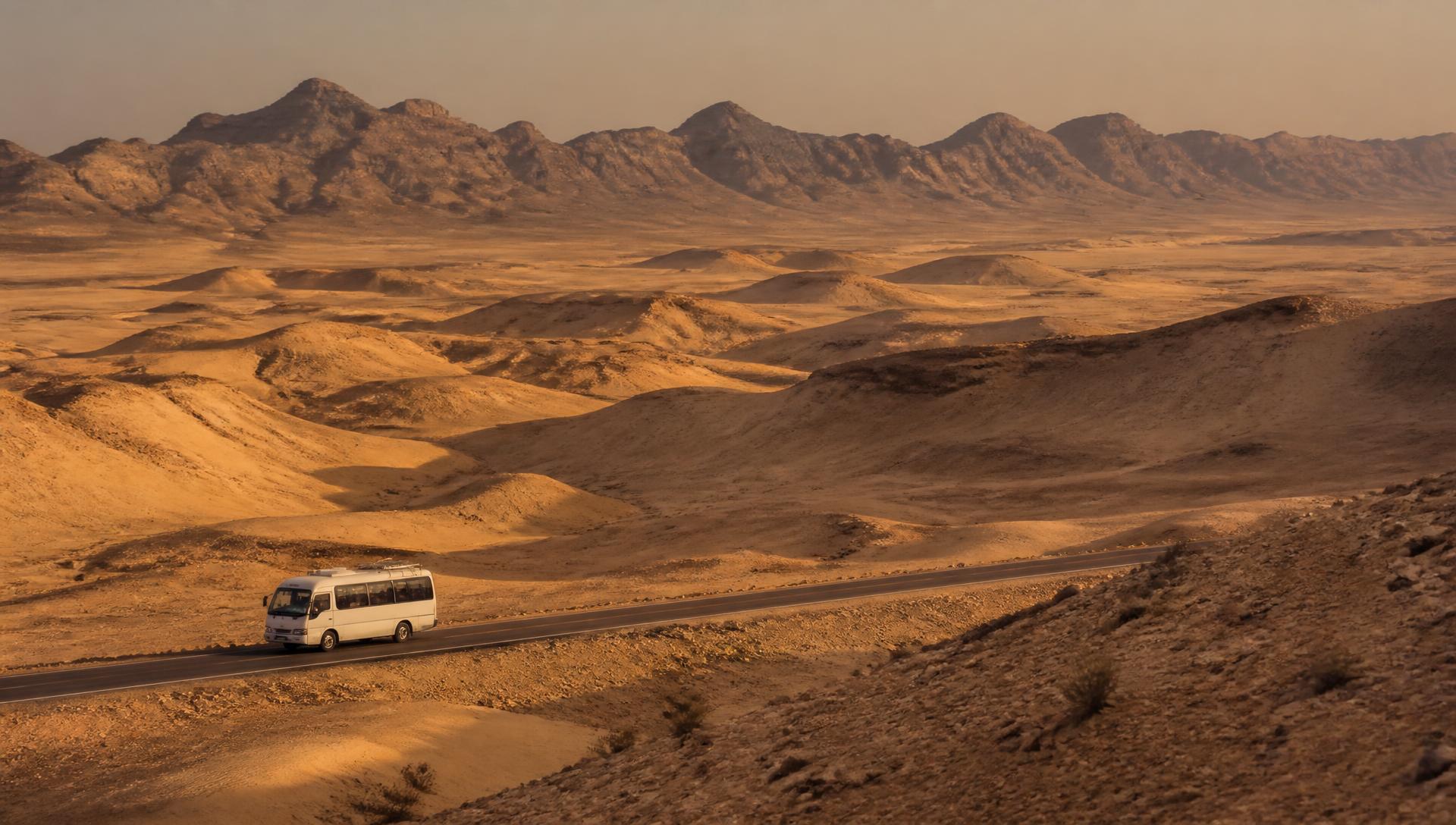 Private minibus crossing the Tunisian desert at golden hour